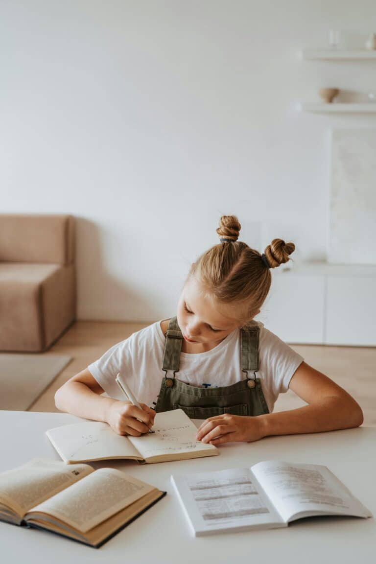 homeschooling an only child - girl at desk with school books